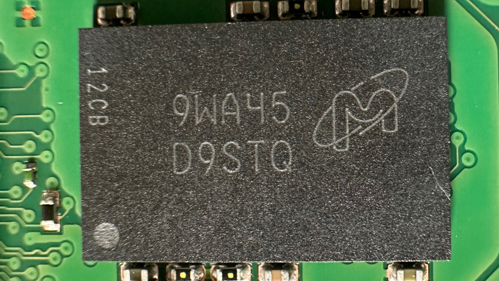 Micron 1GB DDR3L-1600 SDRAM Cache Chip D9STQ Macro Photography on Micron 5210 ION PCB