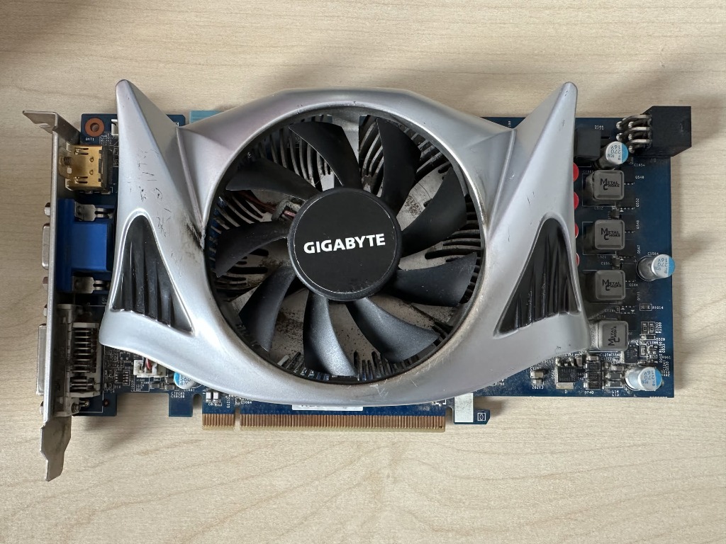 Gigabyte GeForce GTS 250 512MB graphics card front view showing aerodynamic silver shroud and axial fan